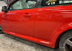 Red vehicle side panel after repair