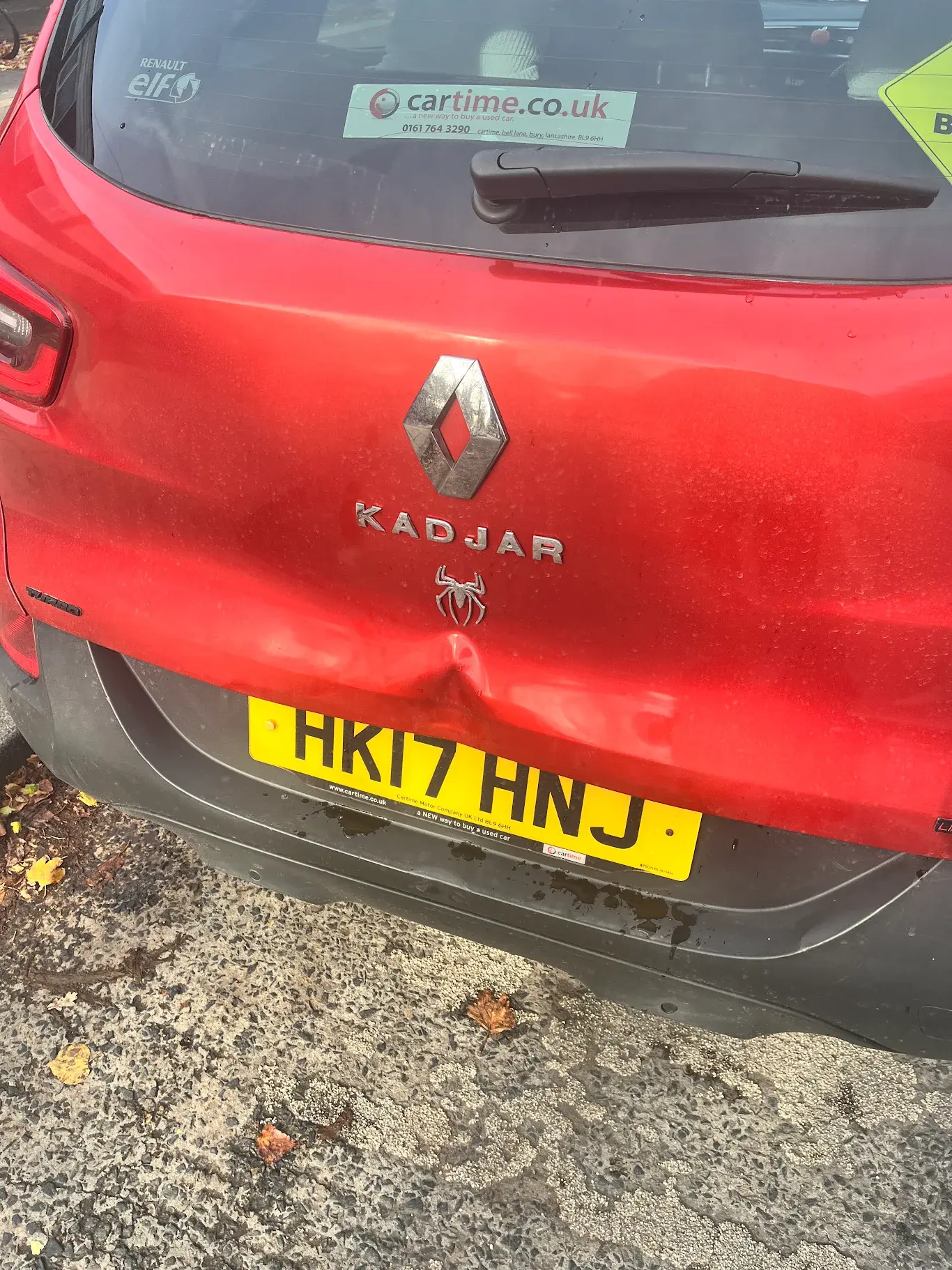 Red tailgate before dent repair